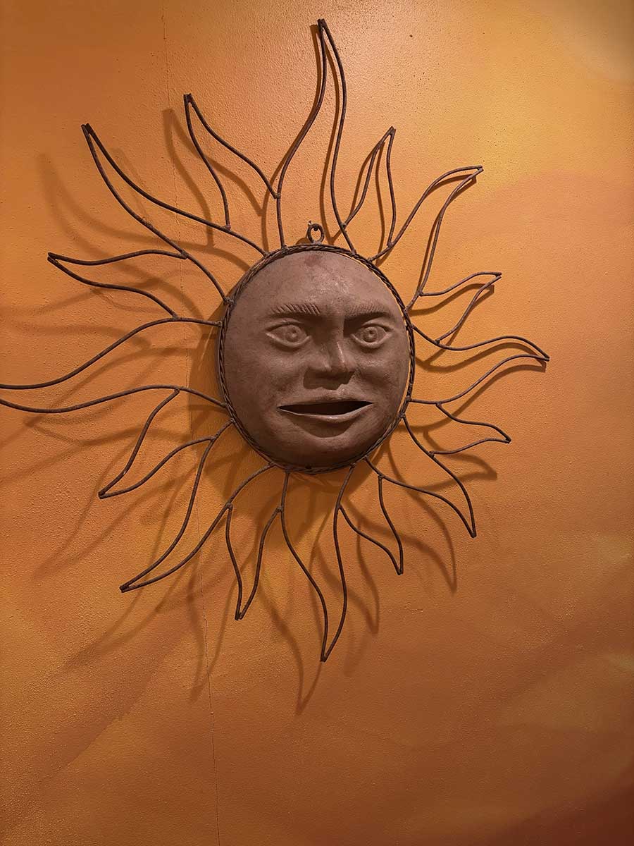 Sun artisan decor on the warm walls at Celestial Sun