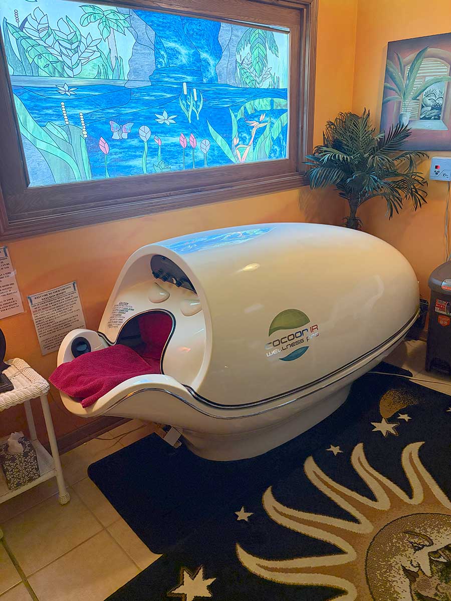 Cocoon IR Wellness Pro Pod with stained-glass window background at Celestial Sun Byron IL
